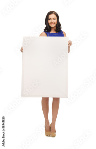 Photo: lovely woman in blue dress with blank board lovely woman in blue dress with blank board