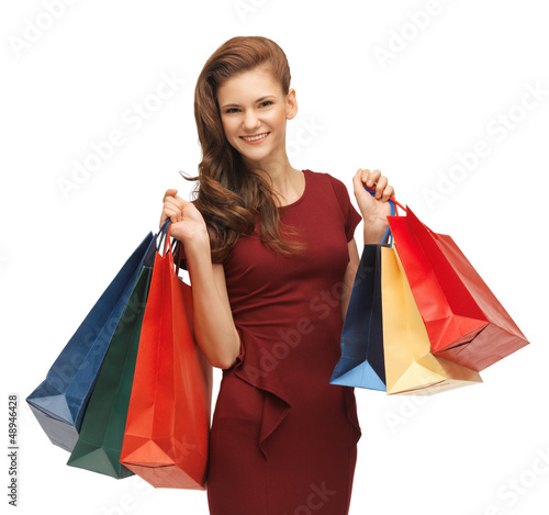 Photo: teenage girl in red dress with shopping bags teenage girl in red dress with shopping bags