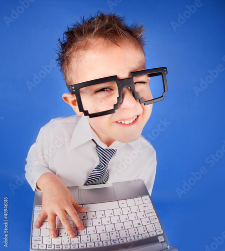 Photo: Five years old boy with a laptop computer Five years old boy with a laptop computer