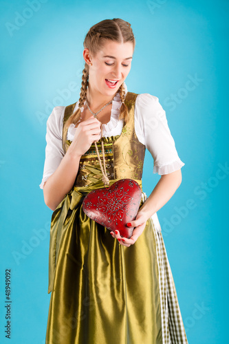 Photo: Young woman in traditional clothes - dirndl or tracht Young woman in traditional clothes - dirndl or tracht