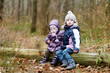 Two sisters sitting on a tree