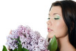 Photo: Beautiful woman with spring flowers of a lilac. Skincare Beautiful woman with spring flowers of a lilac. Skincare