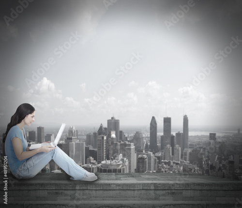 Photo: Young woman with laptop computer. Young woman with laptop computer.