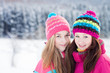 Two young girl friends in winter outdoors. Holidays. Happy Teens