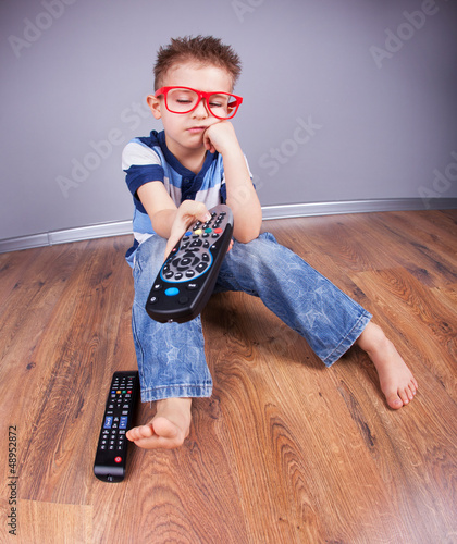 Photo: Five years old bored boy watching tv Five years old bored boy watching tv
