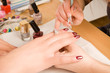 Woman with nail brush drawing on nails