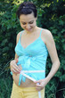 Pregnant woman measuring abdomen.