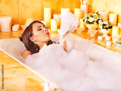 Photo: Woman relaxing at bubble bath. Woman relaxing at bubble bath.