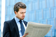 Business man reading a newspaper