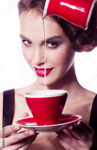 Photo: young woman with fashion makeup and tea cup young woman with fashion makeup and tea cup