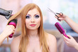 Beautiful woman and hands with brushes, scissors and hairdryer