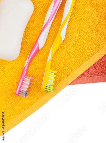 Photo: Toothbrushes, soap and two towels Toothbrushes, soap and two towels