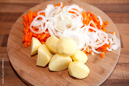 Photo: Ingredients for Dutch hutspot stew on wooden cutting board Ingredients for Dutch hutspot stew on wooden cutting board