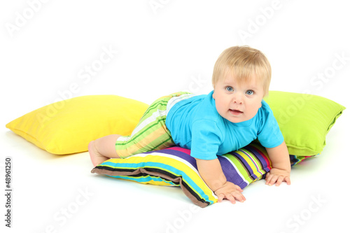 Photo: Little boy and color pillows, isolated on white Little boy and color pillows, isolated on white