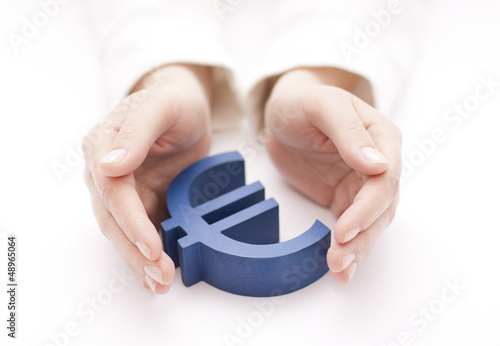 Photo: Euro sign protected by hands Euro sign protected by hands