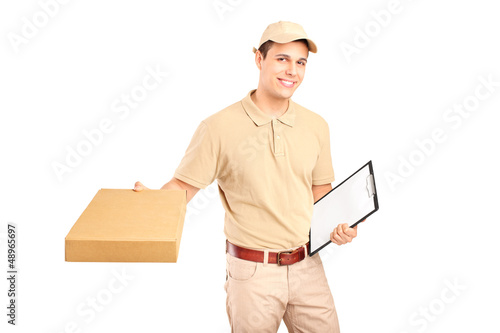 Photo: A delivery person delivering a packet and holding a clipboard A delivery person delivering a packet and holding a clipboard