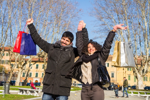 Photo: Happy Young Couple with Shopping Bags Happy Young Couple with Shopping Bags