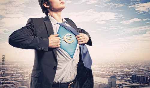Photo: Businessman showing superman suit underneath shirt Businessman showing superman suit underneath shirt