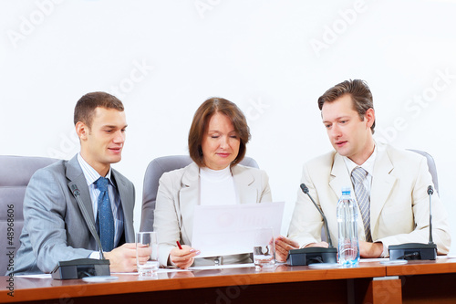 Photo: Three businesspeople at meeting Three businesspeople at meeting