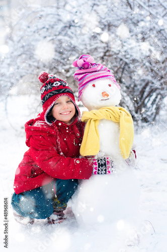 Photo: Little girl and snowman Little girl and snowman
