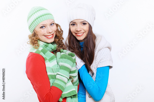 Photo: Young woman wearing winter hat and warm scarf Young woman wearing winter hat and warm scarf