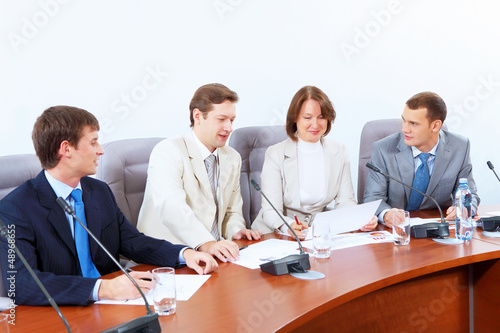 Photo: Four businesspeople at meeting Four businesspeople at meeting