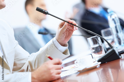 Photo: Hands of businessman holding microphone Hands of businessman holding microphone