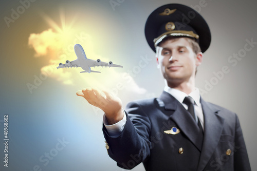 Photo: Image of pilot with plane in hand Image of pilot with plane in hand