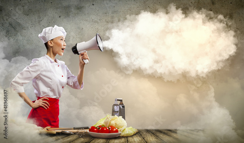 Photo: Asian female cook holding megaphone Asian female cook holding megaphone