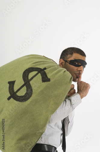 Photo: Robber Sneaking Away With Money Robber Sneaking Away With Money