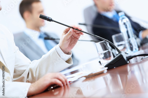 Photo: Hands of businessman holding microphone Hands of businessman holding microphone