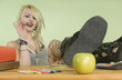Teenage Student Sitting With Her Feet On Desk
