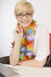 Blond Woman Wearing A Lei At Work