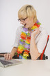 Blond Woman On The Computer Wearing A Lei