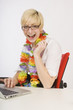 Very Happy Woman Sitting At Desk Wearing A Lei