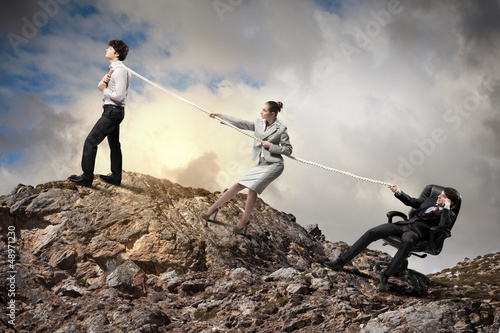 Photo: Three business people pulling rope Three business people pulling rope