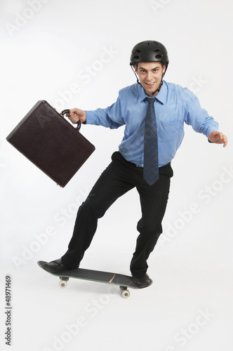 Photo: Businessman On Skateboard Businessman On Skateboard