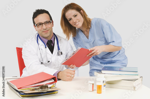Photo: Doctor And Nurse Looking At Chart Doctor And Nurse Looking At Chart