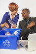Woman Showing Coworker Recycling Procedures