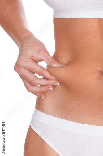Photo: woman pinches fat on the belly, isolated on white woman pinches fat on the belly, isolated on white