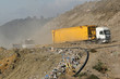 Garbage trucks delivering waste to a landfill site