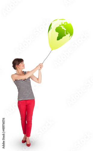 Photo: Happy lady holding a green globe balloon Happy lady holding a green globe balloon