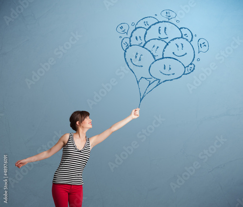 Photo: Happy woman holding smiling balloons drawing Happy woman holding smiling balloons drawing