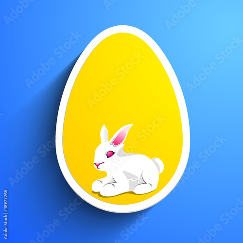 Vector: Little Easter Rabbit in the yellow Easter Egg on blue background Little Easter Rabbit in the yellow Easter Egg on blue background