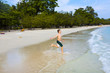 young happy boy with brown hair enjoys  jumping in the beautiful