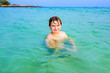 handsome boy has fun in the ocean