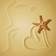 Hearts on the sand background with starfish