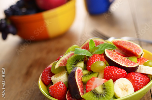 Photo: Healthy fruit mix salad on the kitchen table Healthy fruit mix salad on the kitchen table