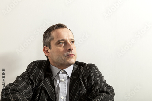 Photo: portrait of adult man,. wall white background portrait of adult man,. wall white background