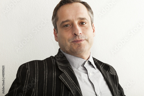 Photo: portrait of adult man, wall white background portrait of adult man, wall white background